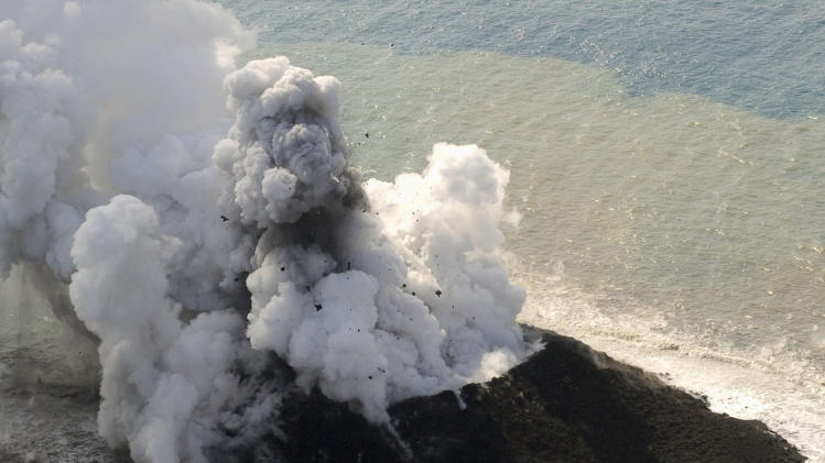 Smoke billows from a new island off the coast of Nishinoshima, a small, uninhabited island in the Ogasawara chain, far south of Tokyo Thursday, Nov. 21, 2013. The Japan Coast Guard and earthquake experts said a volcanic eruption has raised the new island in the seas to the far south of Tokyo. The coast guard issued an advisory Wednesday warning of heavy black smoke from the eruption. (AP Photo/Kyodo News) JAPAN OUT, MANDATORY CREDIT
