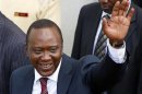 President-elect of Kenya Uhuru Kenyatta waves to his supporters in front of a church in his hometown Gatundu
