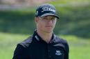 Morgan Hoffmann acknowledges the gallery after putting on the 18th green during the second round of the Arnold Palmer Invitational golf tournament in Orlando, Fla., Friday, March 20, 2015. (AP Photo/Phelan M. Ebenhack)