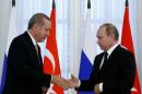 Russian President Putin shakes hands with Turkish President Erdogan during news conference following their meeting in St. Petersburg