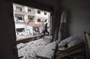A Free Syrian Army fighter walks in a building destroyed during clashes in Haresta neighbourhood of Damascus