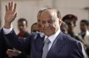FILE - In this Tuesday, Feb. 21, 2012 file photo,Yemen's then Vice President Abed Rabbo Mansour Hadi waves as he enters a polling center to cast his vote in Sanaa, Yemen. Yemen's Shiite rebels said Tuesday, Feb. 24, 2015 that President Abed Rabbo Mansour Hadi, who fled the rebel-controlled capital earlier this month and has begun reconstituting his authority in the south, is 