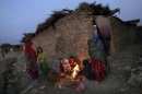 Afghan refugee children gather around a fire to warm themselves, in a slum on the outskirts of Islamabad, Pakistan, Monday, Nov. 26, 2012. (AP Photo/Muhammed Muheisen)