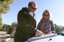 Rassie Erasmus, left, and his wife Yolanda Erasmus, of Cape Town, South Africa, look at a map to plan their next drive in an attempt to see the Grand Canyon, as the main entrance to Grand Canyon National Park remains closed to visitors due to the continued federal government shutdown on Friday Oct. 11, 2013, in Grand Canyon, Ariz.(AP Photo/Ross D. Franklin)