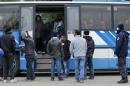 Migrants enter a bus at a Croatia-Slovenia border crossing in Lendava, Slovenia