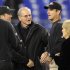 Baltimore Ravens head coach John Harbaugh, left, and his brother, San Francisco 49ers head coach Jim Harbaugh, second from right, talk with their father, Jack, center, and mother, Jackie, before their NFL football game in Baltimore on Thursday, Nov. 24, 2011. (AP Photo/Nick Wass)