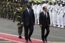 French President Francois Hollande, right, and Senegalese counterpart Macky Sall walk past an honor guard as Hollande arrives at the airport in Dakar, Senegal, Friday, Oct. 12, 2012. Hollande was on a one-day visit to Senegal Friday, en route to Kinshasa, Congo for the Francophonie Summit. (AP Photo/Rebecca Blackwell)