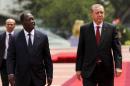 Turkish President Tayyip Erdogan walks with Ivory Coast's President Alassane Ouattara at the presidential palace in Abidjan