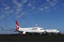A Qantas Airlines Boeing 737 plane sits next to a Virgin Australia Boeing 737 plane at the Port Hedland airport in the Pilbara region of western Australia