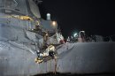 In this image released by the U.S. Navy, the U.S. Navy's guided-missile destroyer is seen damaged after it collided with a Japanese-owned oil tanker just outside the strategic Strait of Hormuz, Sunday, Aug. 12, 2012. The collision left a gaping hole in the starboard side of USS Porter but no one was injured on either vessel, the U.S. Navy said in a statement. (AP Photo/U.S. Navy, Jonathan Sunderman)