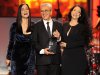 Caetano Veloso, center, accepts his award at the 2012 Latin Recording Academy Person of the Year Tribute to Caetano Veloso at the MGM Grand Garden Arena on Wednesday, Nov. 14, 2012, in Las Vegas. Presenting the award from left are Julieta Venegas and Sonia Braga. Photo by Powers Imagery/Invision/AP)