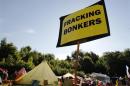 An anti-fracking sign is displayed at the protest camp by the entrance to a site run by Cuadrilla Resources outside the village of Balcombe in southern England