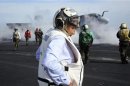 U.S. Defense Secretary Panetta watches day flight operations from the flight deck of the aircraft carrier USS Enterprise, off the coast of Georgia