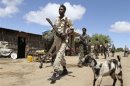 Somali government soldiers patrol the streets in Lafole village, near Afgoye district in Mogadishu