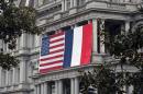 French and US flags hang on the Eisenhower Executive Office Building of the White House, in Washington, DC, on February 7, 2014, three days before the arrival of French President Francois Hollande for a three-day state visit