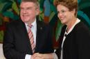 Brazil's President Dilma Rousseff, right, shakes hands with International Olympic Committee President Thomas Bach at the Planalto presidential palace in Brasilia, Brazil, Tuesday, Feb. 24, 2015. The IOC's coordination commission is visiting venues and meeting with local organizers as Rio races to be ready on time for South America's first games, set for 2016. (AP Photo/Eraldo Peres)