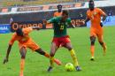 Cameroon's Maxim Choupo-Moting (centre) fends off Ivory Coast's Jean-Daniel Akpa-Akpro (left) and midfielder Cheick Tiote during a 2015 African Cup of Nations qualifier in Yaounde on September 10, 2014