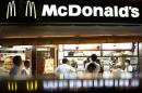 Passersby walk past a McDonald's store in Tokyo