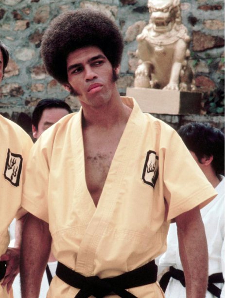 This 1973 photo released by Warner Bros. Entertainment shows Jim Kelly as Williams in a scene from "Enter the Dragon." Kelly, who played a glib American martial artist in "Enter the Dragon" with Bruce Lee, died Saturday, June 29, 2013 of cancer at his home in San Diego. He was 67. Sporting an Afro hairstyle and sideburns, Kelly made a splash with his one-liners and fight scenes in the 1973 martial arts classic. (AP Photo/Warner Bros. Entertainment)