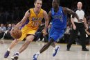 Lakers point guard Steve Nash drives up the key against Mavericks point guard Darren Collison