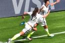 USA's Carli Lloyd (R) celebrates a goal against Japan with teammate Lauren Holiday during the 2015 FIFA Women's World Cup final at BC Place Stadium in Vancouver, British Columbia on July 5, 2015