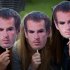 Fans pose with masks of Andy Murray as they queue for tickets for the second day at Wimbledon