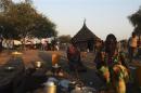 Women displaced by the unrest in Bor county cook in Minkaman, in Awerial county, Lakes state