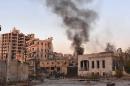 Smoke billows in Aleppo's Bustan al-Basha neighbourhood on November during Syrian pro-government forces assault to retake the entire northern city from rebel fighters