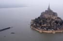An aerial view as a high tide submerges a narrow causeway leading to the Mont Saint-Michel, on France's northern coast, Saturday, March 21, 2015. A supertide has turned France’s famed Mont Saint-Michel into an island and then retreated out of sight, delighting thousands of visitors who came to see the rare phenomenon. The so-called “tide of the century” actually happens every 18 years (AP Photo) FRANCE OUT