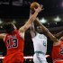 Boston Celtics' Green drives to the basket between Chicago Bulls' Noah and Gibson in their NBA basketball game in Boston