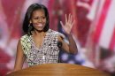 First Lady Michelle Obama waves from the podium during a sound check at the Democratic National Convention in Charlotte, N.C., on Monday, Sept. 3, 2012. (AP Photo/J. Scott Applewhite)