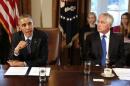 U.S. President Obama speaks as Secretary of Defense Hagel listens before the start of a Cabinet Meeting in the Cabinet Room at the White House in Washington