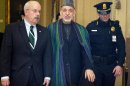 Afghanistan President Hamid Karzai, is escorted by Sergeant of Arms of the Senate Terrance Gainer, left, as he walks to a meeting with U.S. sanators on Capitol Hill in Washington, Wednesday, Jan. 9, 2013. (AP Photo/Manuel Balce Ceneta)