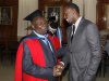 Jamaican sprinter Bolt congratulates his coach Mills after Mills received degree of Doctor Honoris Causa from University of the West Indies in Mona