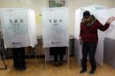 A South Korean woman casts her vote for the presidential election at a local polling station in Seoul, South Korea, Wednesday, Dec. 19, 2012. South Korea's closely contested presidential election will determine how it will pursue relations with neighbors North Korea and Japan, and if it will have its first female leader. (AP Photo/Lee Jin-man)