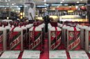 File photo of a customer walking past a glass case displaying Maotai liquors at a supermarket in Shenyang