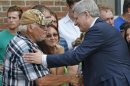 Canada's Prime Minister Stephen Harper shakes hands with people at the Polyvalente Montignac in Lac Megantic
