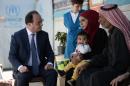 French President Francois Hollande (L) meets with a Syrian family at Dalhamiyeh refugee camp in Lebanon's Bekaa Valley on April 17, 2016
