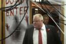 Mayor Rob Ford walks past Halloween decorations on his way to talk to media at City Hall in Toronto on Thursday, Oct. 31, 2013. Ford says he has no reason to step down despite police confirmation that they have seized a video that appears to show him smoking a crack pipe. (AP Photo/The Canadian Press, Frank Gunn)