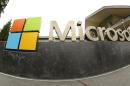 This photo taken July 3, 2014 shows the Microsoft Corp. logo outside the Microsoft Visitor Center in Redmond, Wash. Microsoft reports quarterly earnings on Tuesday, July 22, 2014. (AP Photo Ted S. Warren)