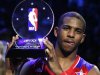 NBA All-Star Chris Paul of the Los Angeles Clippers holds up the MVP trophy after the 2013 NBA All-Star basketball game in Houston