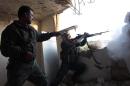 Rebel fighters fire a machine gun during clashes with pro-government forces on March 18, 2014 in the northern Syrian city of Aleppo
