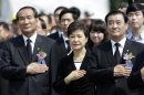 South Korean President Park Geun-hye, center, salutes to a national flag during a 58th Memorial Day ceremony at the National Cemetery in Seoul, South Korea, Thursday, June 6, 2013. (AP Photo/Lee Jin-man, Pool)