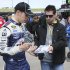 NASCAR Sprint Cup Series driver Brad Keselowski, left, signs autographs in the garage area at Kansas Speedway in Kansas City, Kan., Friday, April 19, 2013. (AP Photo/Colin E. Braley)