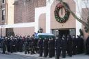 The casket of New York Police Department officer Rafael Ramos arrives to his wake at Christ Tabernacle Church, in the Glendale section of Queens, where he was member, Friday, Dec. 26, 2014, in New York. Ramos was killed Dec. 20 along with his partner, Officer Wenjian Liu, as they sat in their patrol car on a Brooklyn street. The shooter, Ismaaiyl Brinsley, later killed himself. (AP Photo/John Minchillo)