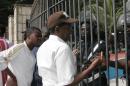 Sidy Lamine Niass (centre) talks with riot police in front of the National assembly in Dakar on June 23, 2011