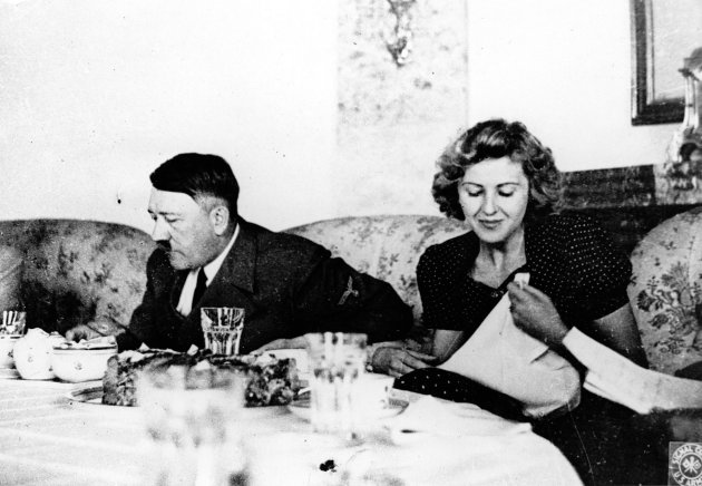 FILE - This undated file picture shows the German Fuehrer Adolf Hitler and his mistress Eva Braun while dining. A German woman named Margot Woelk was one of 15 young women who sampled Hitler's food to make sure it wasn’t poisoned before it was served to the Nazi leader in his "Wolf's Lair," the heavily guarded command center in what is now Poland, where he spent much of his time in the final years of World War II. Margot Woelk kept her secret hidden from the world, even from her husband then, a few months after her 95th birthday, she revealed the truth about her wartime role. (AP Photo/US Army Signal Corps from Eva Braun's album, File)