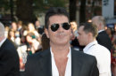 British producer Simon Cowell arrives for the UK Premiere of 'One Direction: This Is Us 3D' at a central London cinema, Tuesday, Aug. 20, 2013. (Photo by Jonathan Short/Invision/AP)