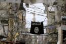An Islamic State flag hangs amid electric wires over a street in Ain al-Hilweh Palestinian refugee camp, near the port-city of Sidon, southern Lebanon
