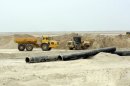 Metal pipes are seen in the massive Majnoon oil field in southeastern Iraq in February 2012